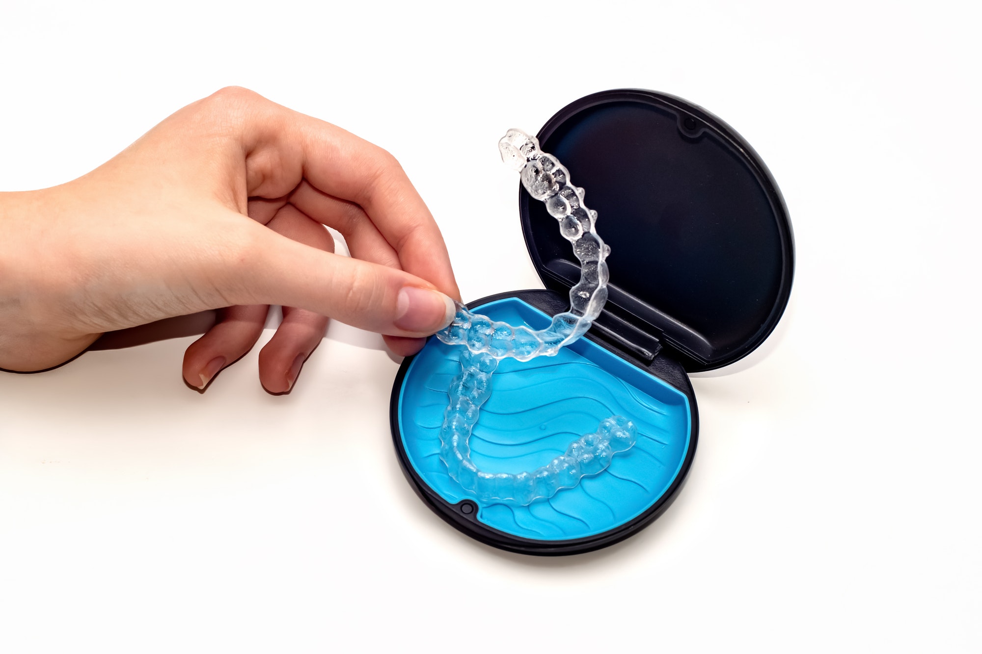 Teeth aligners in a storage case. Invisible braces. Clear teeth straighteners. Clear plastic braces